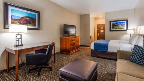 a hotel room with a bed and a desk at Best Western Timpanogos Inn in Lehi