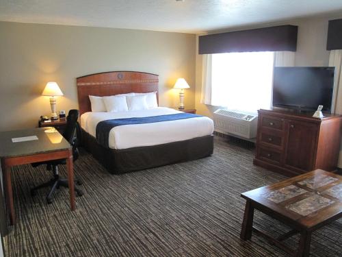 a hotel room with a bed and a flat screen tv at Best Western Timpanogos Inn in Lehi