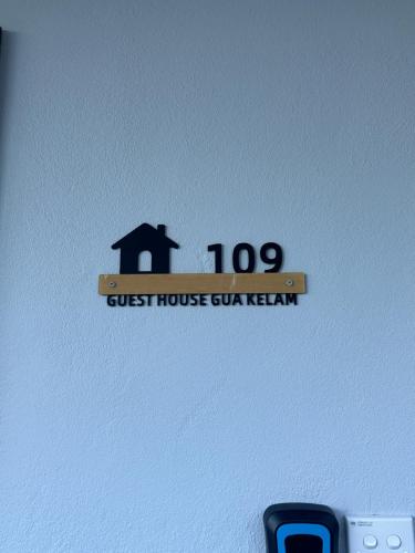 a guest house club kern sign on a wall at Guest House Gua Kelam in Kaki Bukit