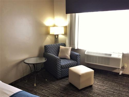 a room with a chair and a table and a window at Best Western Timpanogos Inn in Lehi