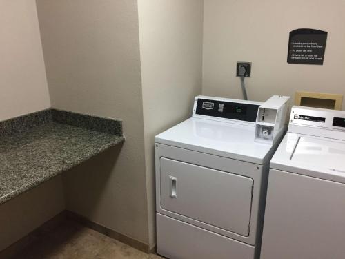 a kitchen with a white stove and a dishwasher at Best Western Timpanogos Inn in Lehi