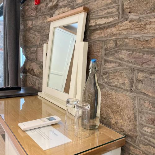 a bottle of wine and two glasses on a table at The Britannia Inn & Waves Restaurant in St Austell