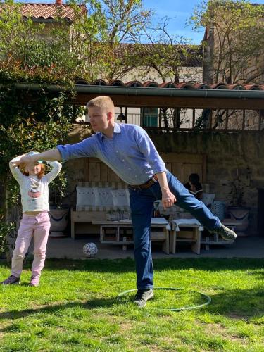 a man and a young child playing with a frisbee at Les FREJALS in Compeyre