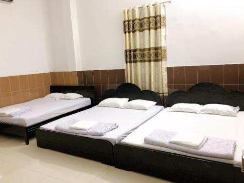 Una cama o camas en una habitación de Kiến An Hotel Cần Thơ