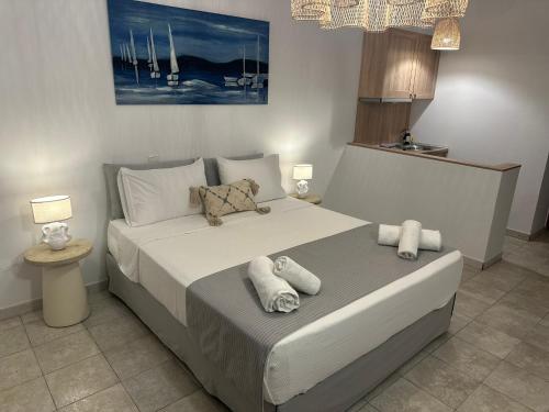 a bedroom with a large bed with towels on it at Dedes Apartments in Skala