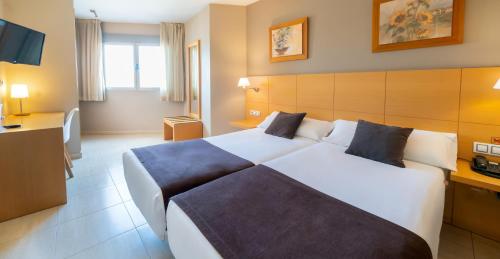 a bedroom with a large bed in a hotel room at La City Estación in Alicante