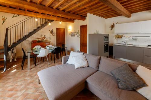 a living room with a couch and a kitchen and a table at Borgo Villa Risi in Siena