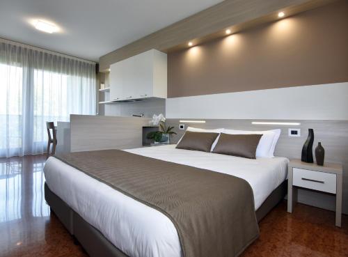 a bedroom with a large bed in a room at Residence all'Adige in Verona