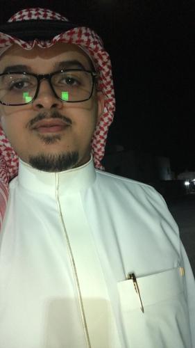 un hombre con gafas y un uniforme blanco en الرياض, en Riad