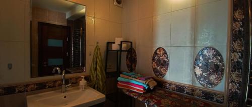 a bathroom with a sink and a mirror at Apartamentai Palangos Centre in Palanga