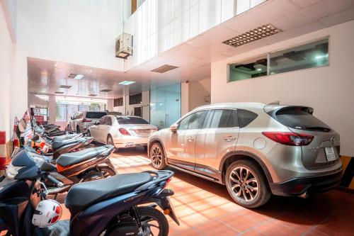 a row of parked cars and motorcycles in a garage at Thien Phu Logia Hotel in Ho Chi Minh City