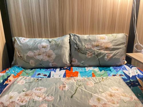 a bed with two pillows on top of it at Start House CAPSULE 5 min walk to the Airport in Ho Chi Minh City
