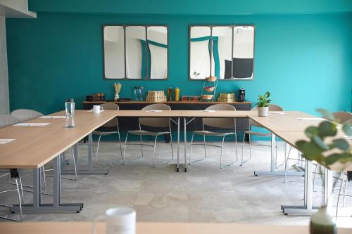 a meeting room with wooden tables and chairs at Appart’City Confort Montpellier Ovalie I in Montpellier