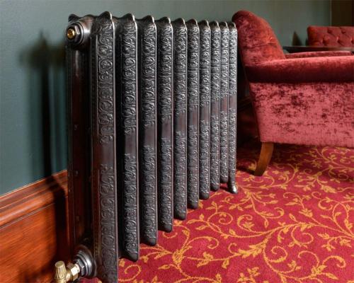 a radiator in a room next to a red chair at Wellwood Manor in Pitlochry