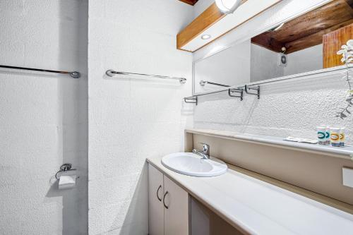 a bathroom with a sink and a mirror at 26 Cottesloe Steps To Beach - Sleeps 2 - SUPERHOG REQUIRED in Perth