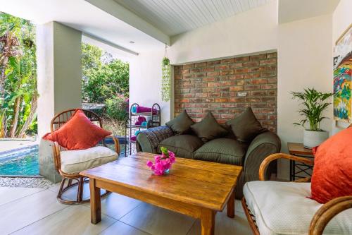 a living room with a couch and a table at Absolute Bosch Guest House in Stellenbosch