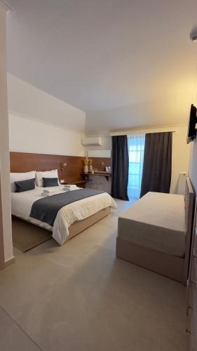 a large bedroom with two beds and a window at Villa Pantheon in Litochoro