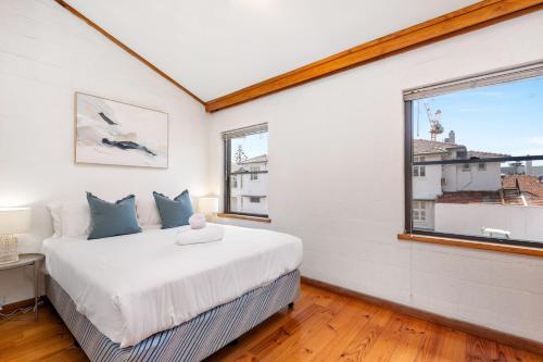 a bedroom with a large bed and a window at 14 Cottesloe - steps from beach - sleeps 2 in Perth