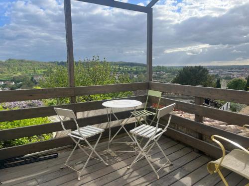 a patio with a table and chairs on a wooden deck at Les Jardins suspendus in Angoulême