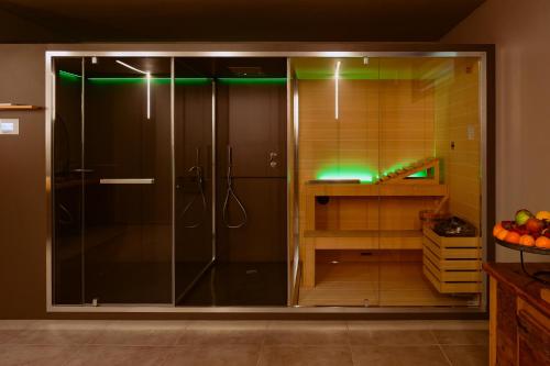 a bathroom with a shower with green lights at Camoma Aparthotel - Suites Apartments in Jesolo