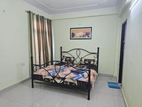 a bedroom with a bed in a room at 3 BHK in Krishna Nagar Lucknow LKO 202R in Lucknow