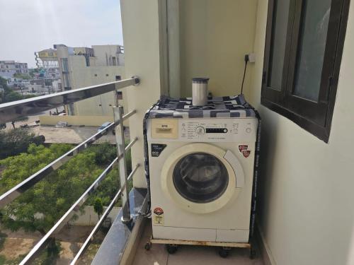 a washing machine sitting on the side of a balcony at 3 BHK in Krishna Nagar Lucknow LKO 202R in Lucknow