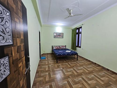 a hallway with a bed in a room at 3 BHK in Krishna Nagar Lucknow LKO 202R in Lucknow