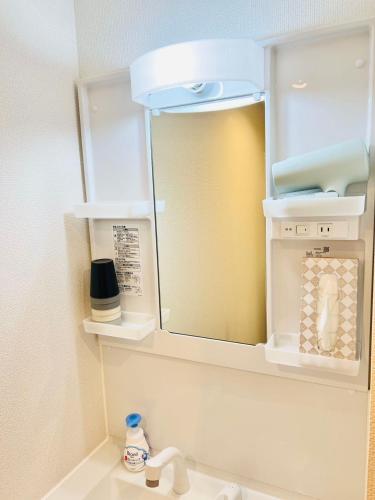 a bathroom with a mirror above a sink at 桜Home in Tokyo