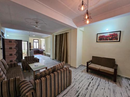 a living room with couches and a couch and a table at 3 BHK in Krishna Nagar Lucknow LKO 202R in Lucknow