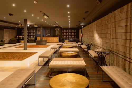 a row of tables and benches in a restaurant at Camoma Aparthotel - Suites Apartments in Jesolo