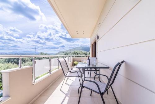 a balcony with a table and chairs and a view at Vacation House close to the Beach in Elia
