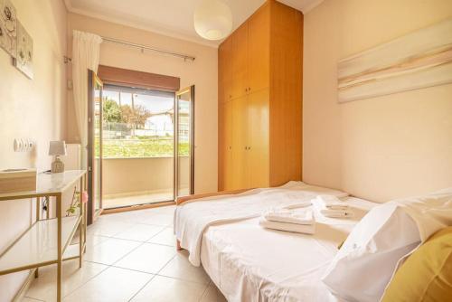a hotel room with a bed and a window at Vacation House close to the Beach in Elia