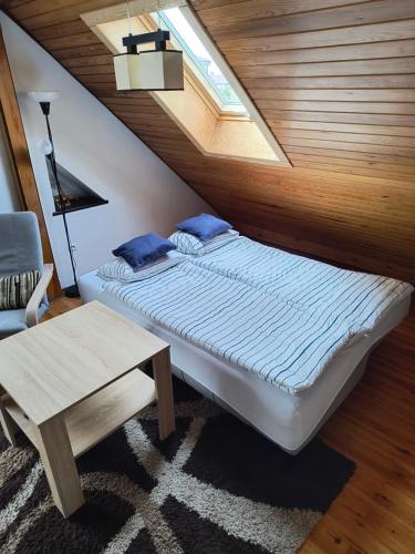 a bedroom with a bed and a skylight at Apartament Pod Orzechem in Augustów