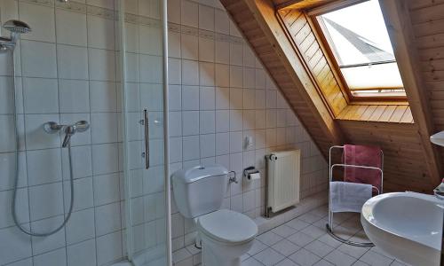 a bathroom with a shower and a toilet and a sink at Kleines Nest in Westerrönfeld