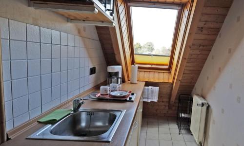 a small kitchen with a sink and a window at Kleines Nest in Westerrönfeld