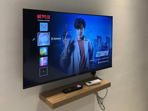 a flat screen tv sitting on a wall at The Urban Left at Horizon Suites KLIA in Kampong Melot