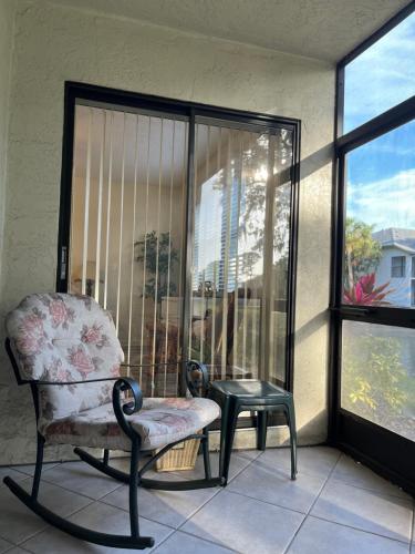 a room with a chair and a table and a window at MyCataleya Beautiful Florida Condo (Bradenton) in Bradenton