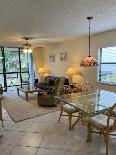 a living room with a glass table and a couch at MyCataleya Beautiful Florida Condo (Bradenton) in Bradenton