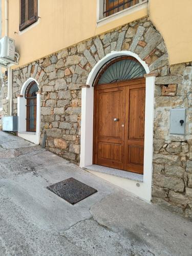 a building with a wooden door on the side of it at Il Frantoio in Lanusei