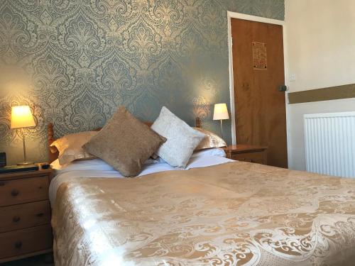 a bedroom with a large bed with two pillows at The Whiteley in Scarborough