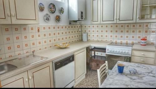 a kitchen with white cabinets and a counter top at Vintage Sleep in Rimini