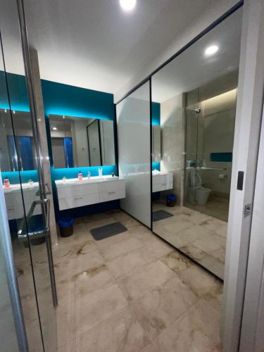 uma casa de banho com 2 lavatórios e um espelho grande em Tropicana The Residences By RS em Kuala Lumpur