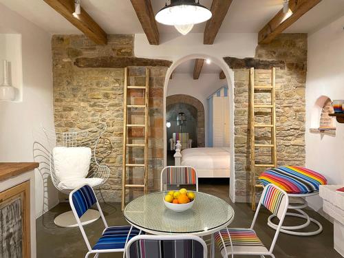 a kitchen with a table and chairs and a bedroom at Castello di Granarola Relais - Adults Friendly - in Gradara