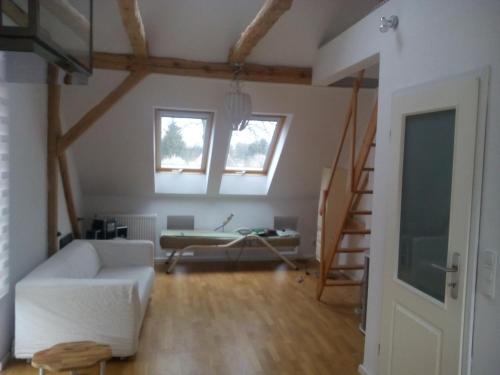 a living room with a white couch and a window at Ferienwohnung am Teupitzsee in Teupitz