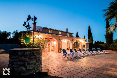 a group of chairs sitting in front of a building at Villa Benimarco by Abahana Villas in Benissa