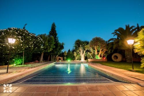 a swimming pool in a backyard at night at Villa Benimarco by Abahana Villas in Benissa