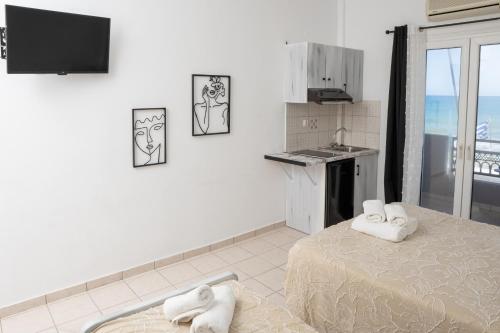 a kitchen with two towels on top of a bed at ARTEMIS beach studios in Kalamaki Heraklion