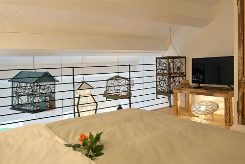 a bedroom with a bed and a desk and a television at Castello di Granarola Relais - Adults Friendly - in Gradara