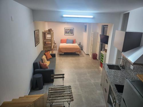 a living room with a bed and a couch at Romantic Studio in Vila do Conde