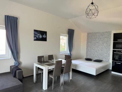 a living room with a dining table and a bed at Apartmán byt 75m2 klid příroda pro rodinu in Prague